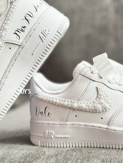 White wedding sneakers embellished with rhinestones, pearls, and subtle bling details