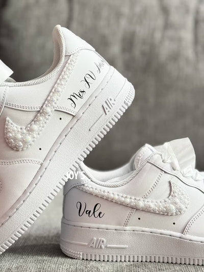 White wedding sneakers embellished with rhinestones, pearls, and subtle bling details