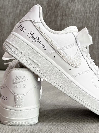 White wedding sneakers embellished with rhinestones, pearls, and subtle bling details