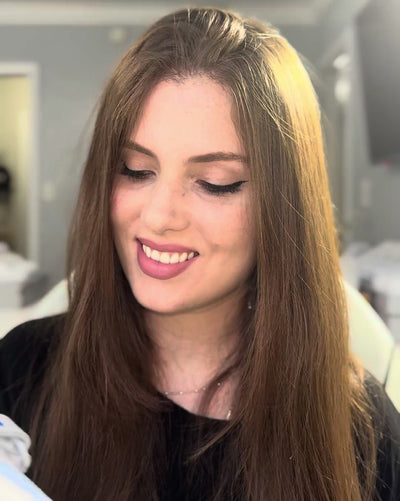 A young lady called Joy, showing a fresh painted pair of Custom Nike Air Force 1 Sneakers with Blue Drip and Butterflies on them 