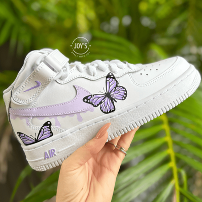 Custom white Nike Air Force 1 sneakers with hand-painted pastel swoosh and butterfly artwork.